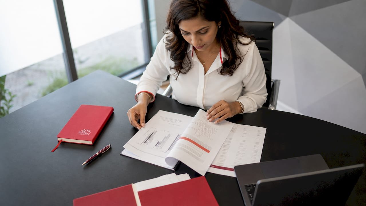 Mortgage broker reviewing documents in office